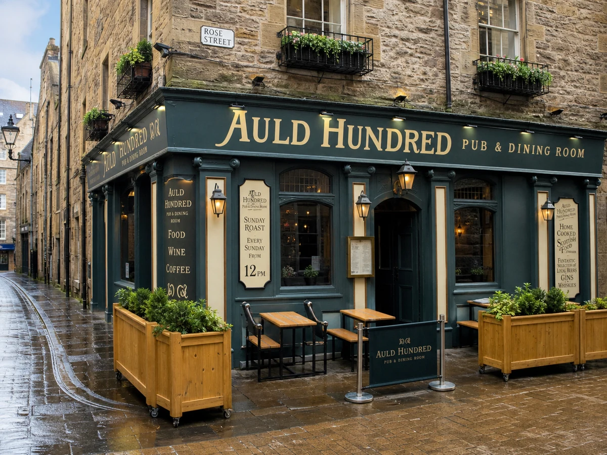 The Auld Hundred’s teal Rose Street corner frontage with cream lettering, lanterns, flower boxes and planters.
