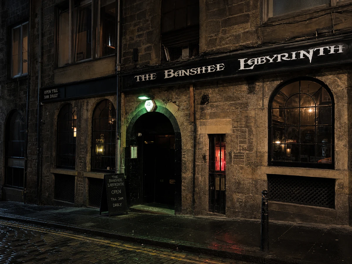 The Banshee Labyrinth’s weathered Niddry Street vault frontage with arched openings, Gothic black fascia and late-night entrance.