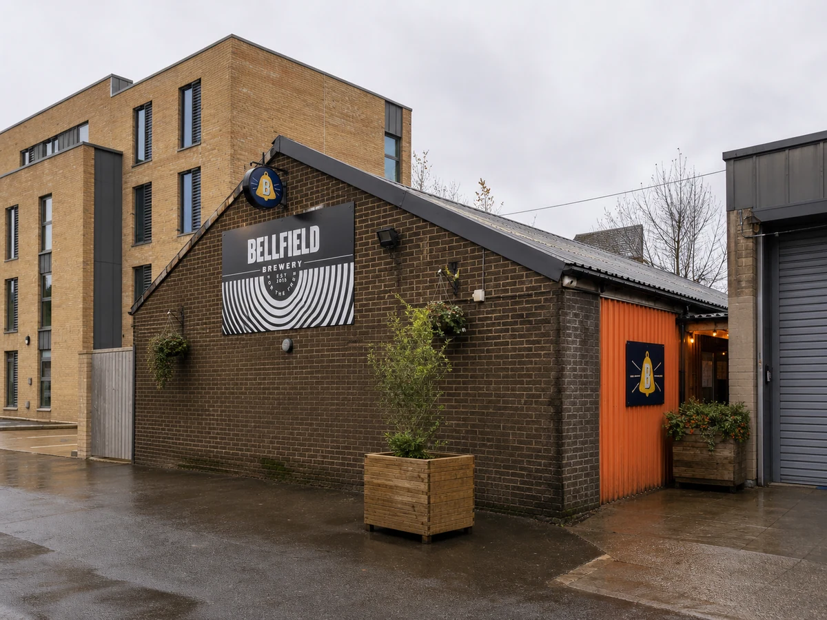 Bellfield Brewery & Taproom’s Stanley Place brick workshop frontage with concentric sign and orange taproom entrance.