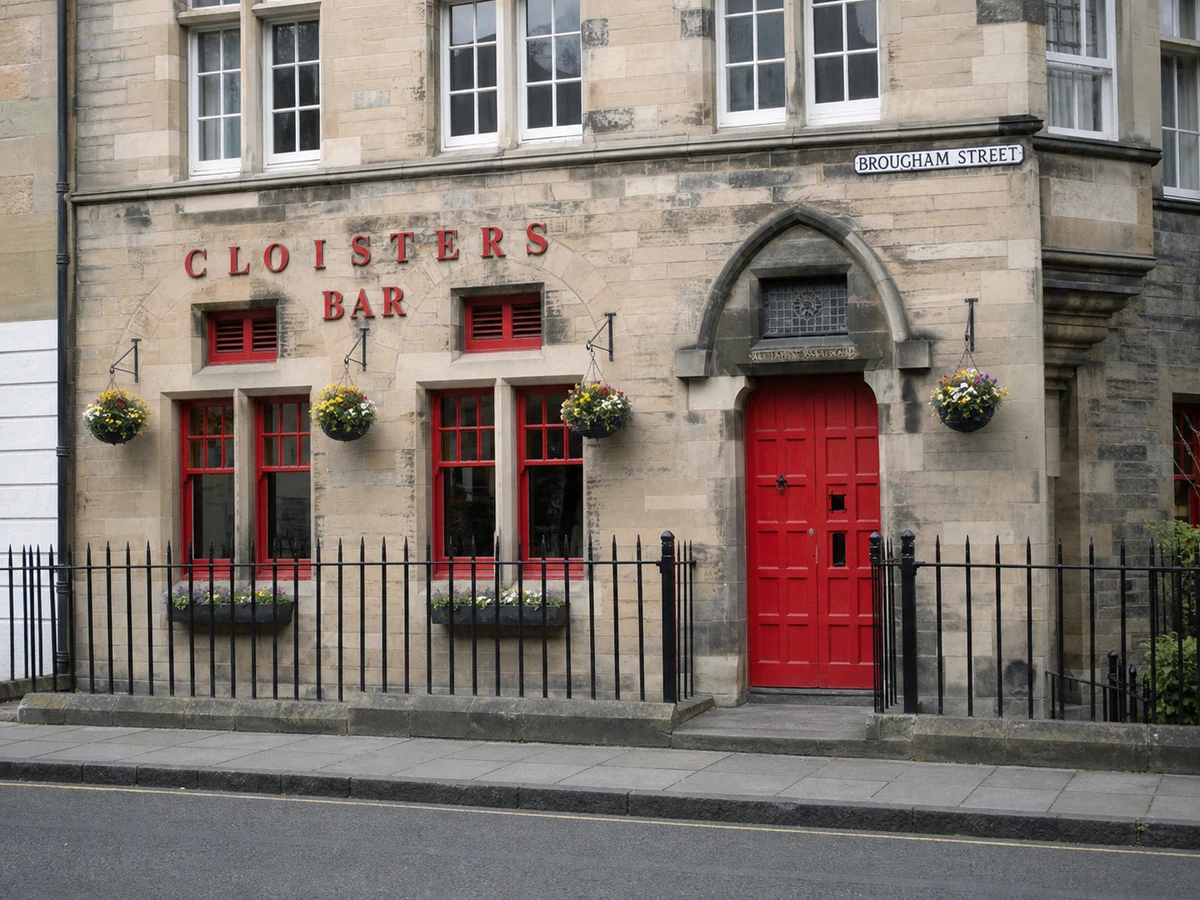 Cloisters Bar’s pale sandstone Brougham Street facade with its red Gothic doorway, red windows and iron fence.