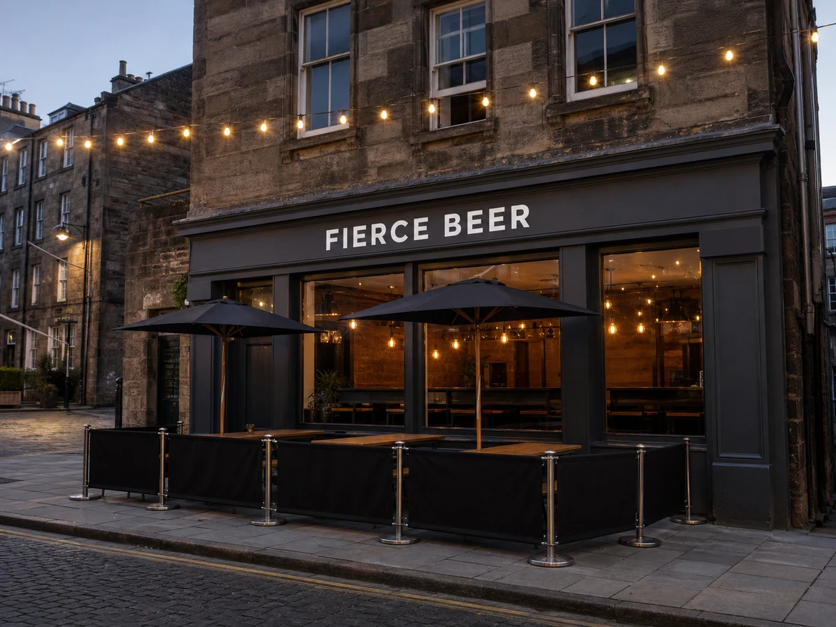 Fierce Beer’s charcoal-grey Rose Street taproom frontage, with its white sign, warm interior lights and compact pavement terrace.