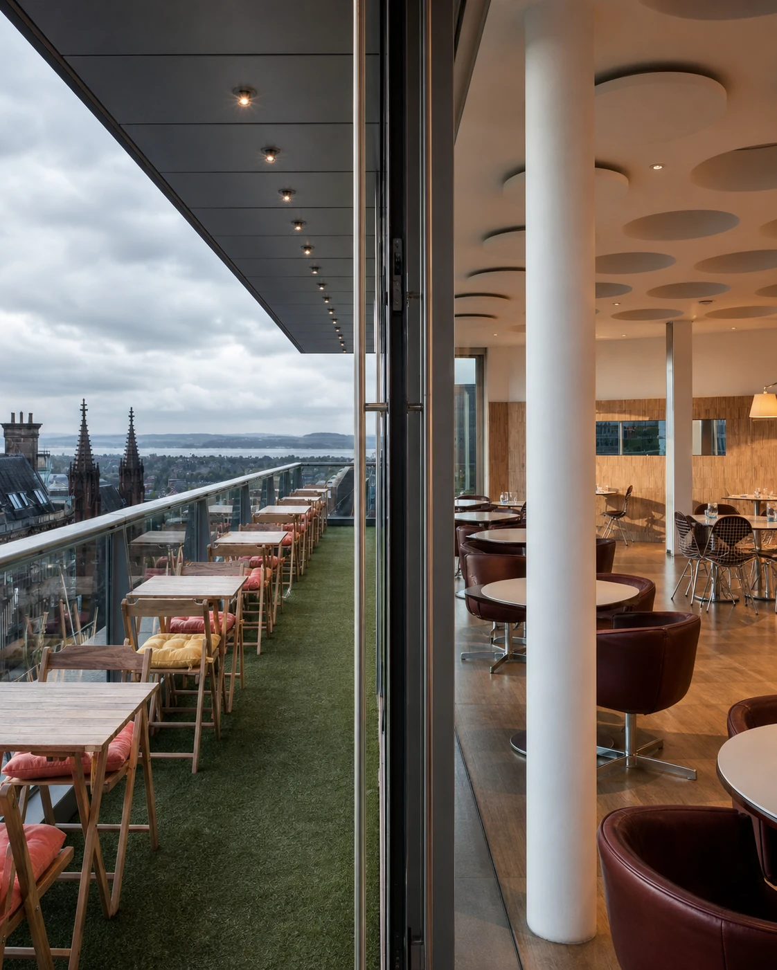 Forth Floor Brasserie & Bar’s exact Harvey Nichols terrace and brasserie, divided by full-height glass above the Edinburgh skyline.