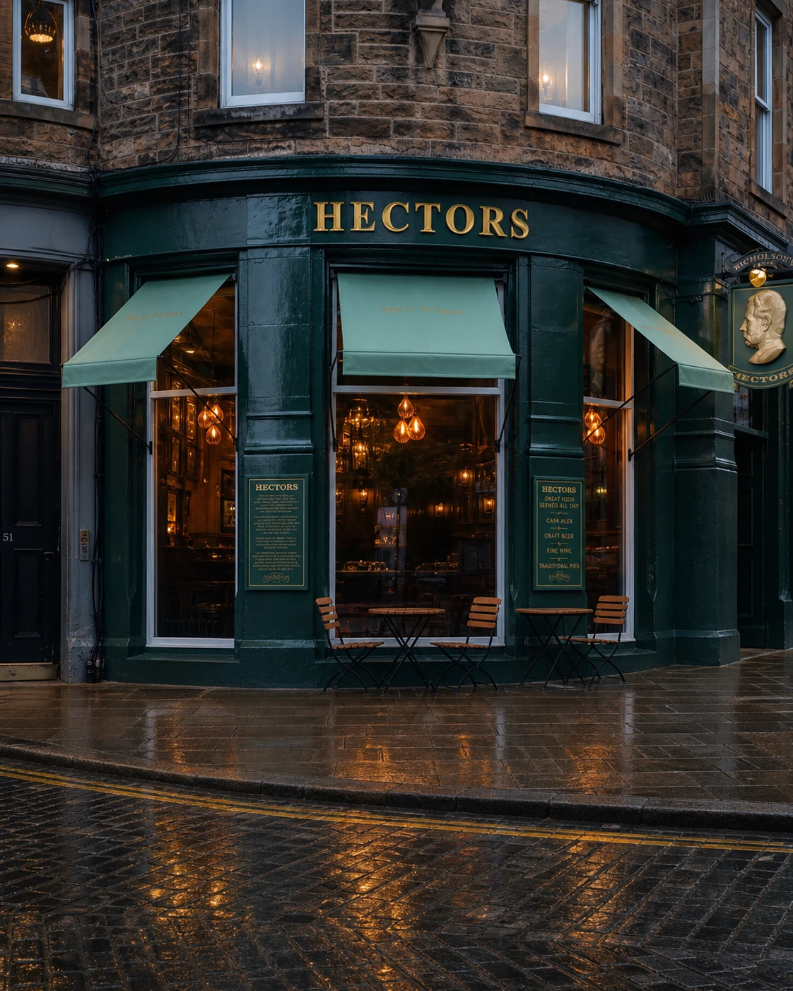 Hectors’ curved dark-green corner frontage with pale awnings, gold name and warm windows after rain.