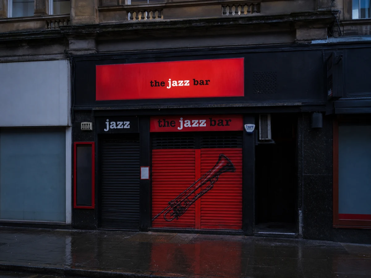 The Jazz Bar’s source-led Chambers Street frontage: black facade, red shutter panels with trombone artwork and crisp “the jazz bar” signage.