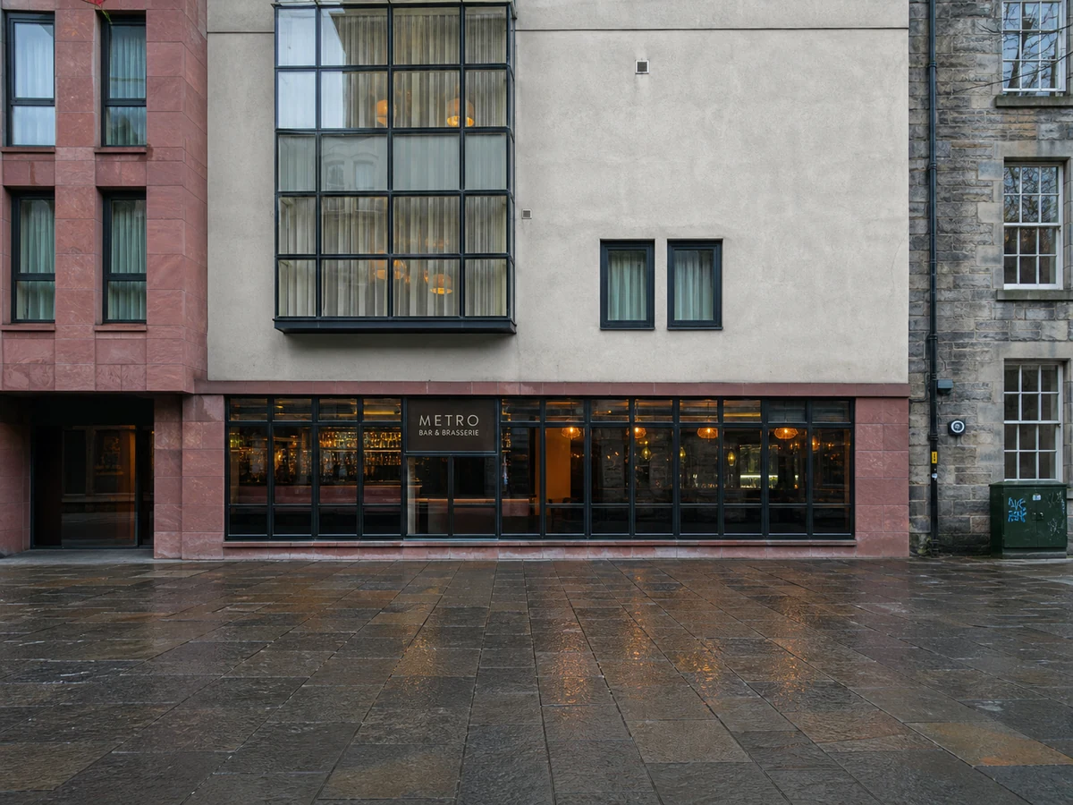 Metro Bar & Brasserie’s source-led Apex Grassmarket frontage, with its modern glazing, muted red-and-grey facade and readable Metro sign.