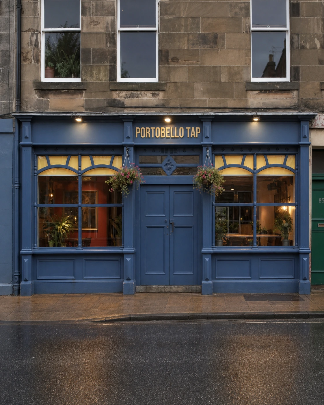 Portobello Tap’s blue frontage with curved windows, central double doors and three lamps beneath a sandstone tenement.