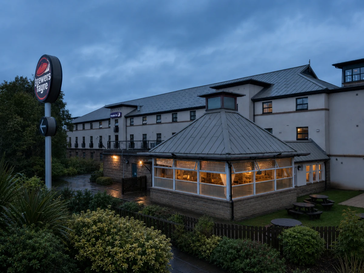 Queen’s Crossing Brewers Fayre’s source-led garden-side setting: its real conservatory pavilion, Premier Inn complex and clear physical Brewers Fayre sign.
