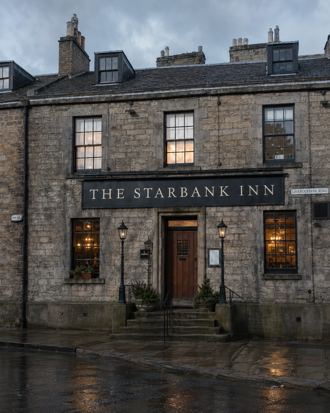 Starbank Inn stone frontage with central steps and doorway, two lower windows and three upper sash windows.