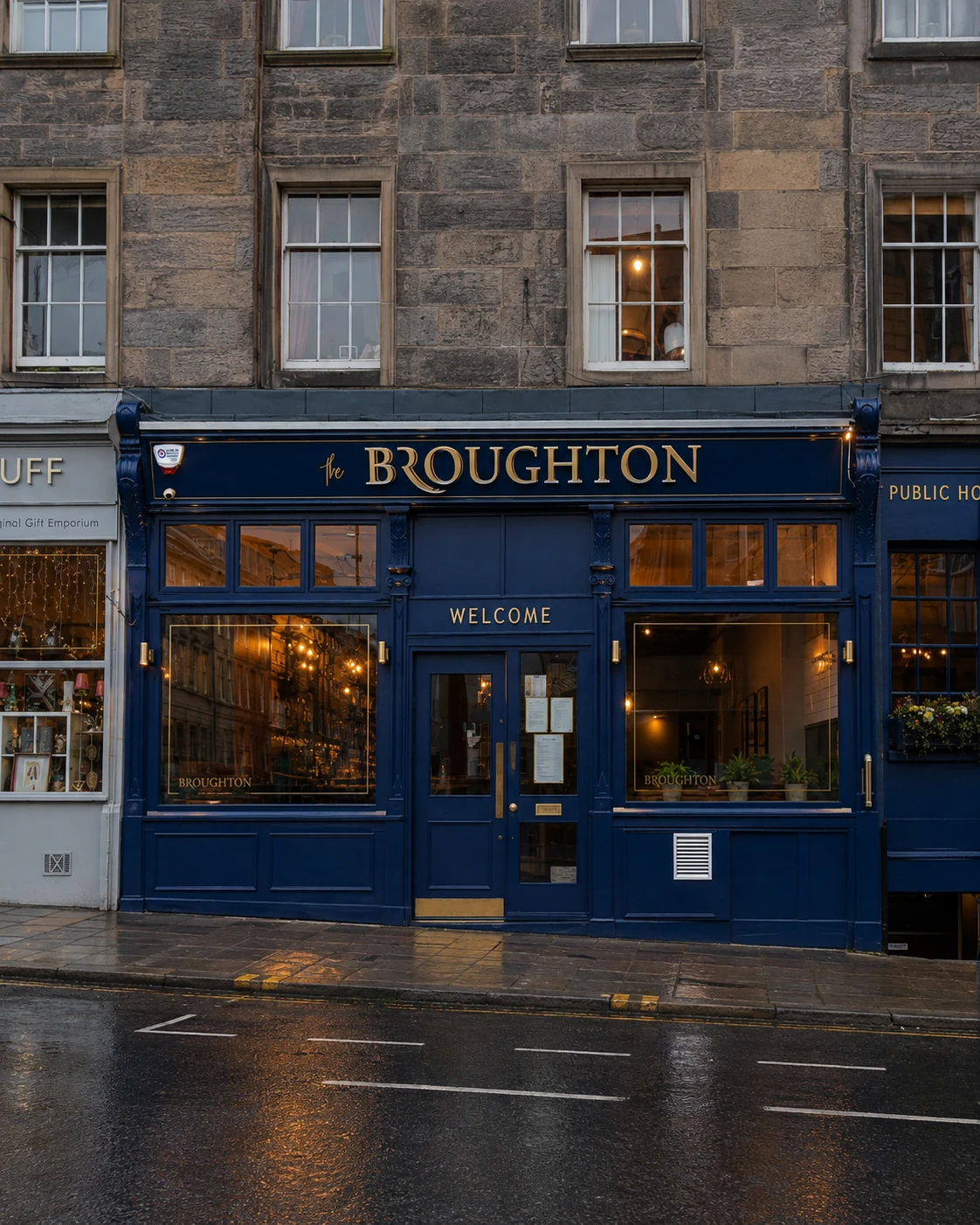 The Broughton’s navy and gold principal frontage, with broad windows around its central entrance.