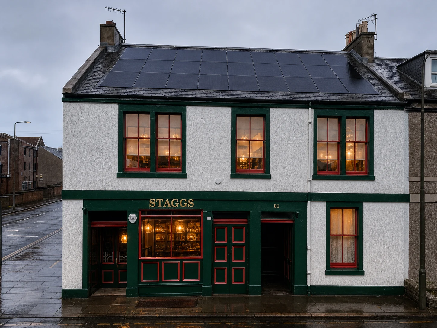 White, dark-green and red Volunteer Arms frontage in Musselburgh with STAGGS clearly lettered in gold and solar panels across the slate roof.