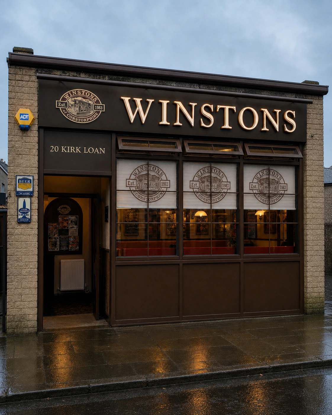 WINSTONS front elevation framed by pale brick piers, with the left doorway, 20 KIRK LOAN panel and three broad windows.